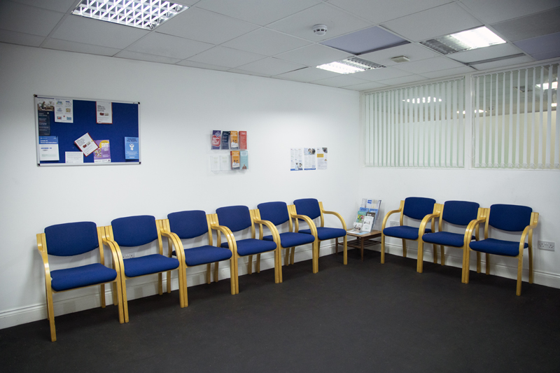 Comfortable waiting area with blue chairs in a Medical GP hospital for events and meetings.