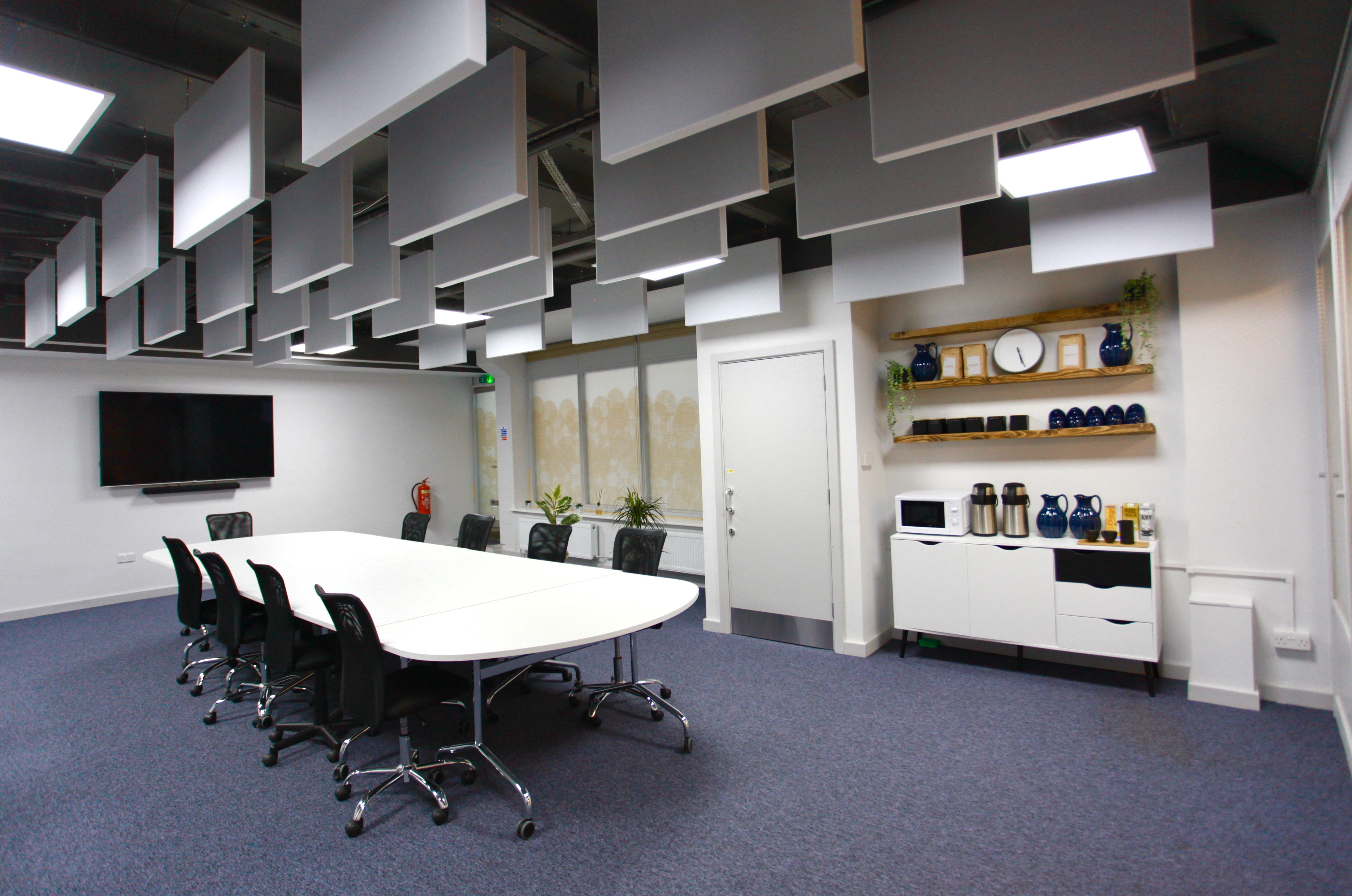 Modern meeting room with oval table, ideal for corporate events and brainstorming sessions.