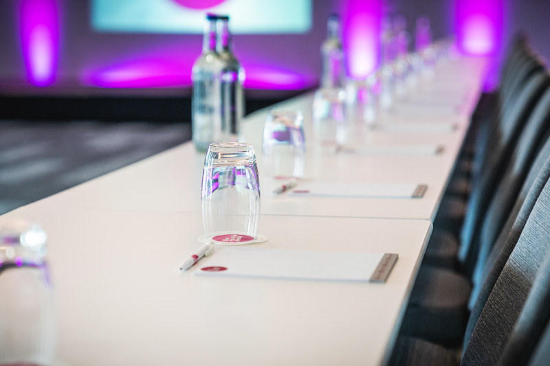 Modern meeting setup at Affinity One, Eastside Rooms with elegant purple lighting.