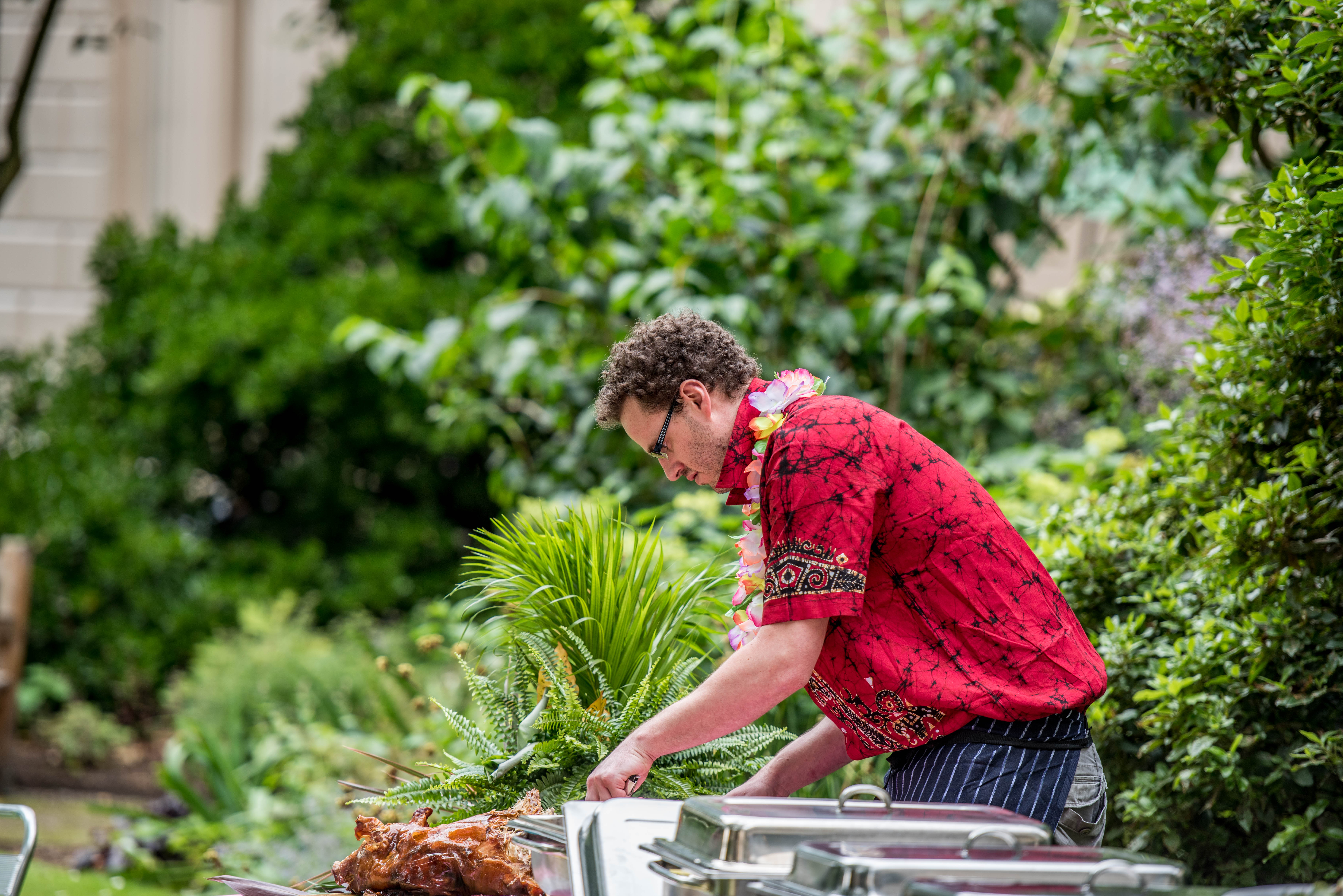 Outdoor tropical-themed summer party catering at Carlton House Terrace, featuring a chef.
