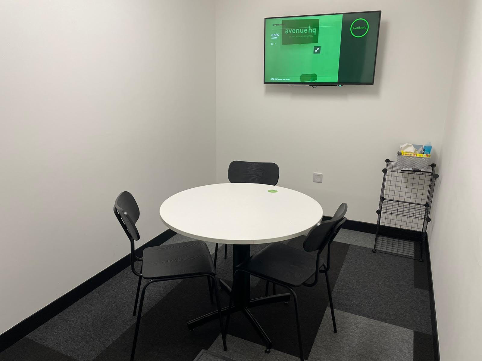 Minimalist meeting room with round table for collaborative brainstorming sessions.
