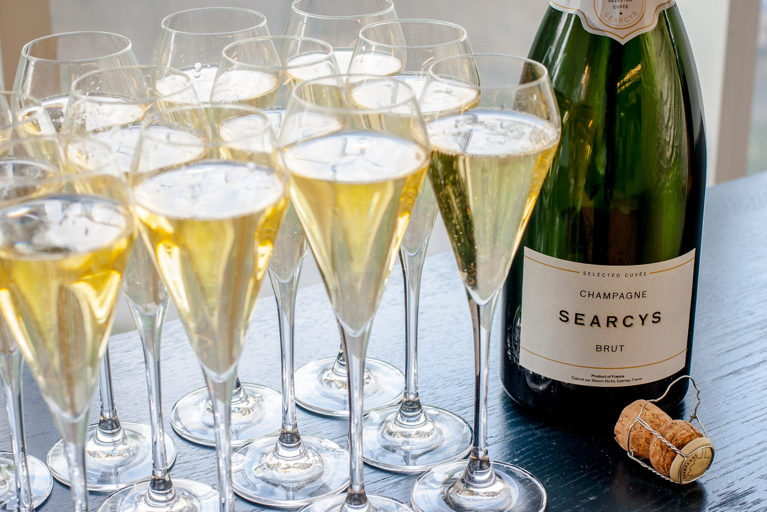 Champagne flutes and Searcys Brut for corporate events celebration.