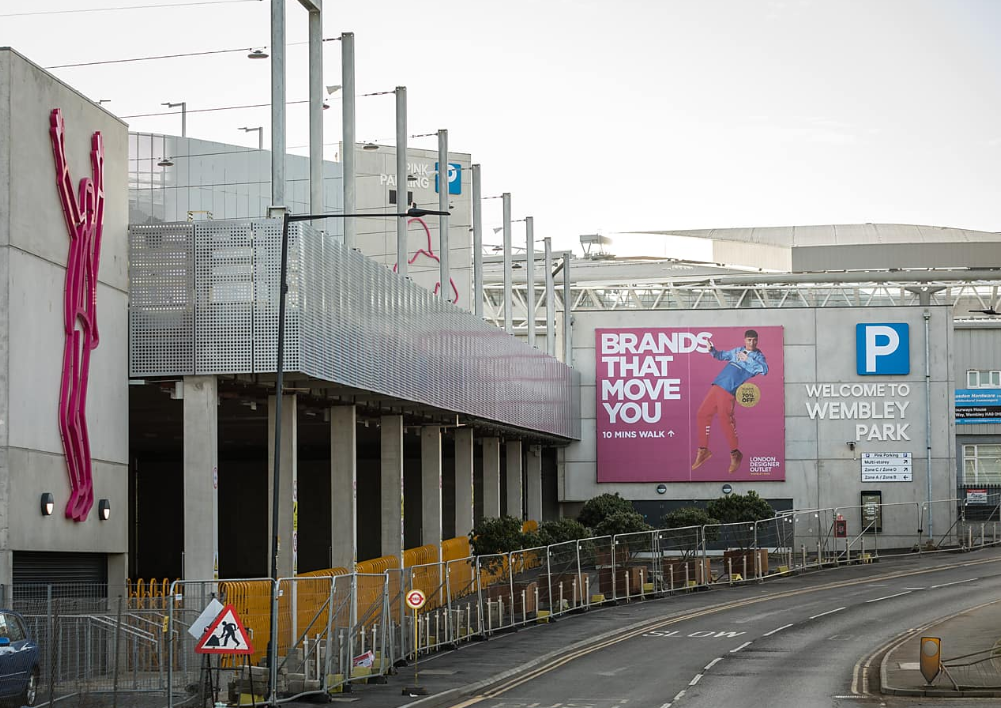 Pink Coach Park in Wembley, vibrant urban venue for events with bold signage.