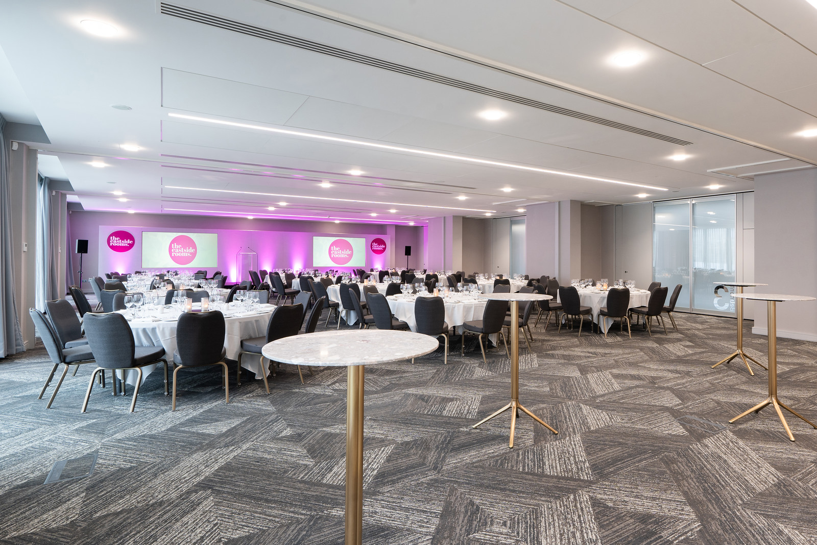 Elegant event space at Belmont Three, ideal for corporate gatherings with round tables.