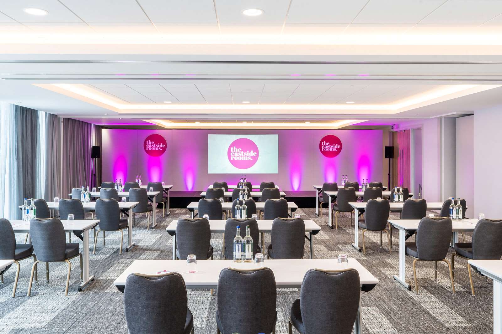Belmont Four meeting room with classroom seating and purple ambient lighting for events.