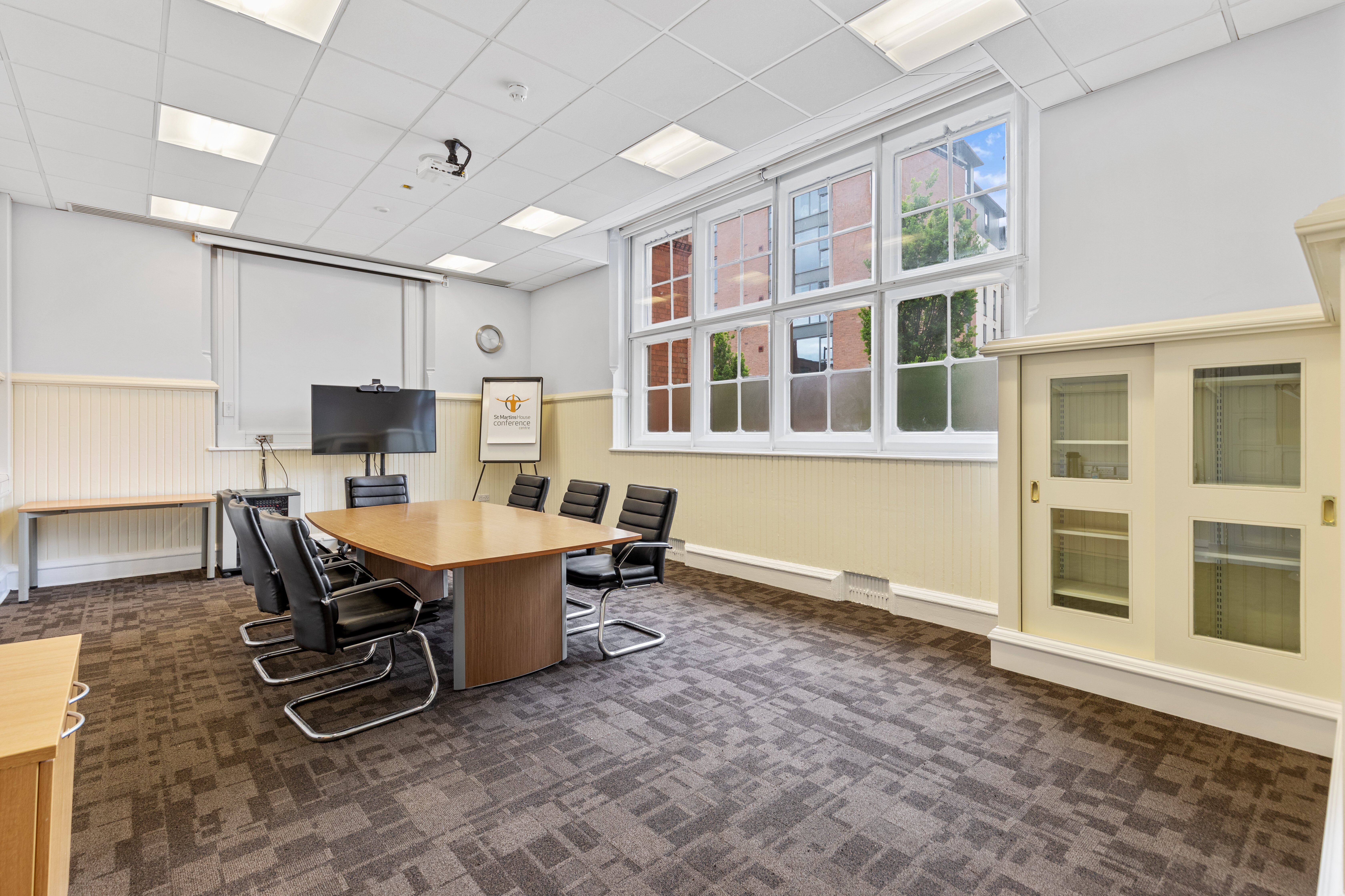 Heyrick Room at St Martins House: bright meeting space with ergonomic chairs for corporate events.