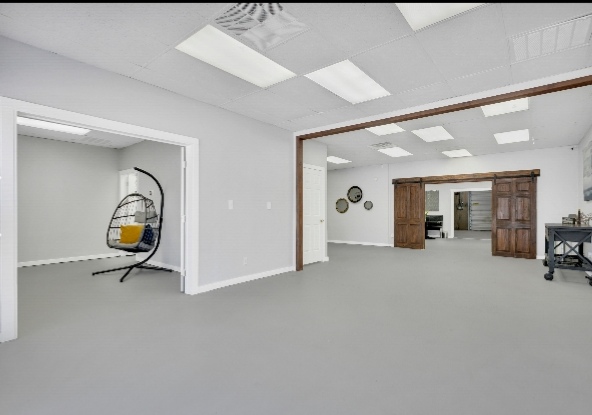 Versatile event space with cozy hanging chair for meetings and workshops.