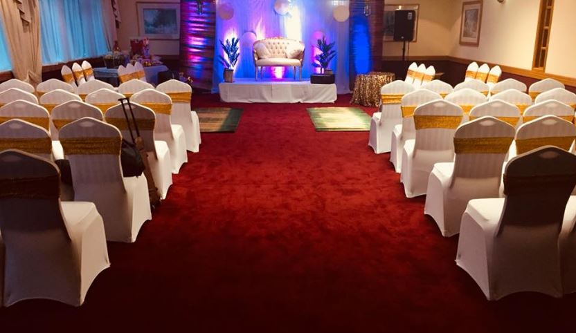 Wansbeck Suite at Britannia Hotel: elegant event space with white chairs and gold sashes.
