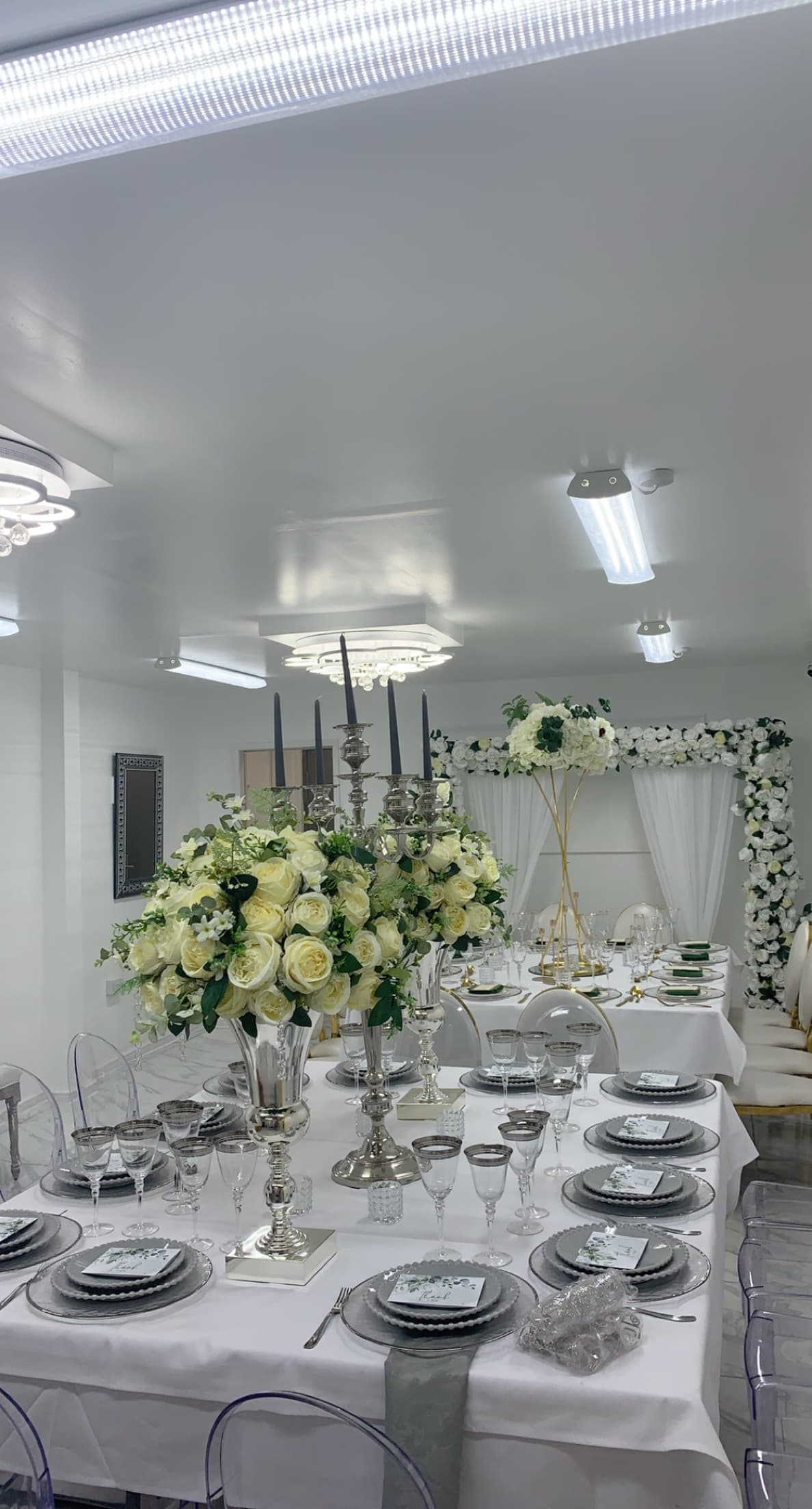 Elegant event space at G LUXE Place with floral centerpieces, perfect for weddings.