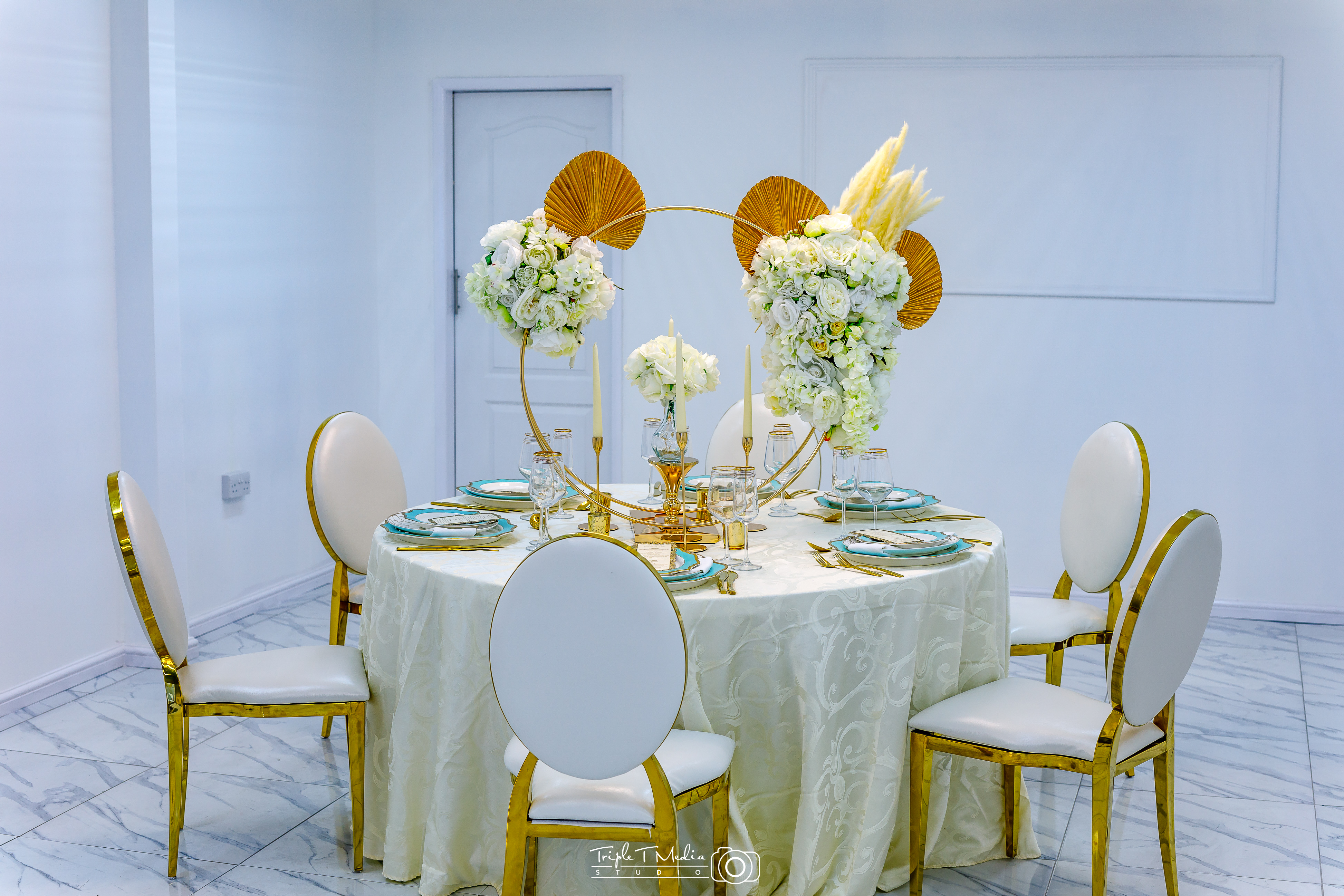 Elegant round table setup with floral arrangements for upscale events at G LUXE Place.