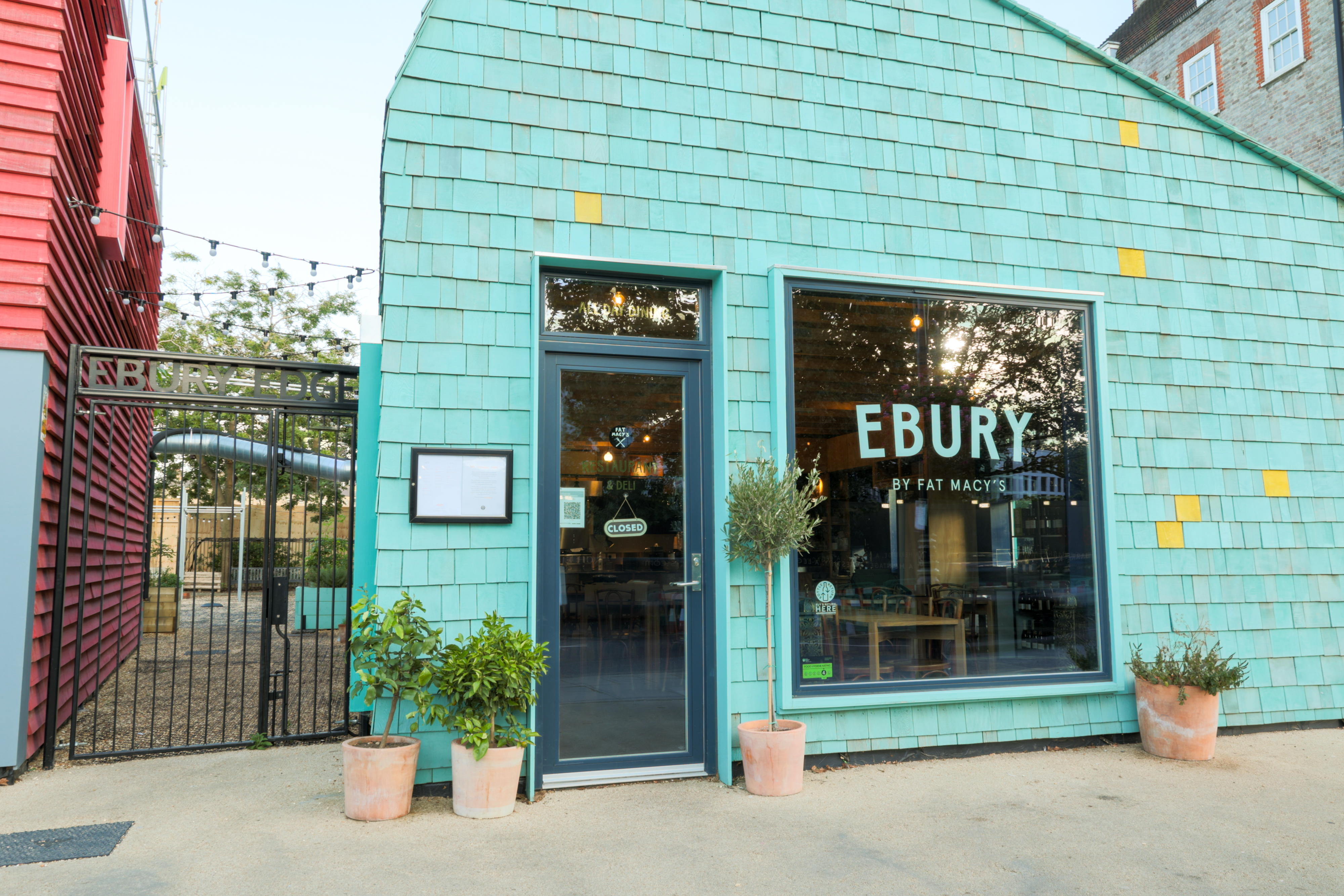 Turquoise wedding venue with large windows, perfect for events and gatherings.