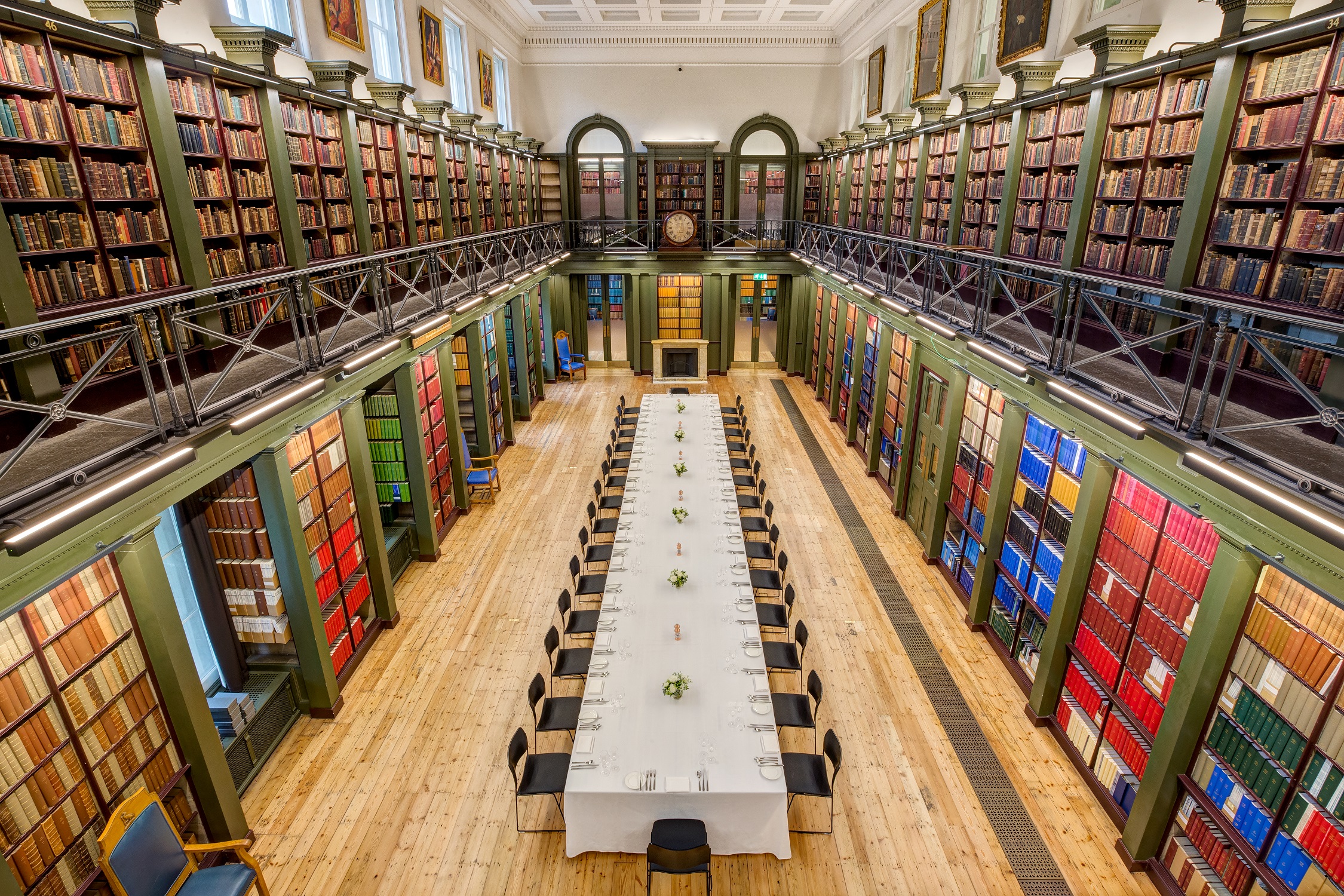 Elegant library venue with towering bookshelves for high-end meetings and events.