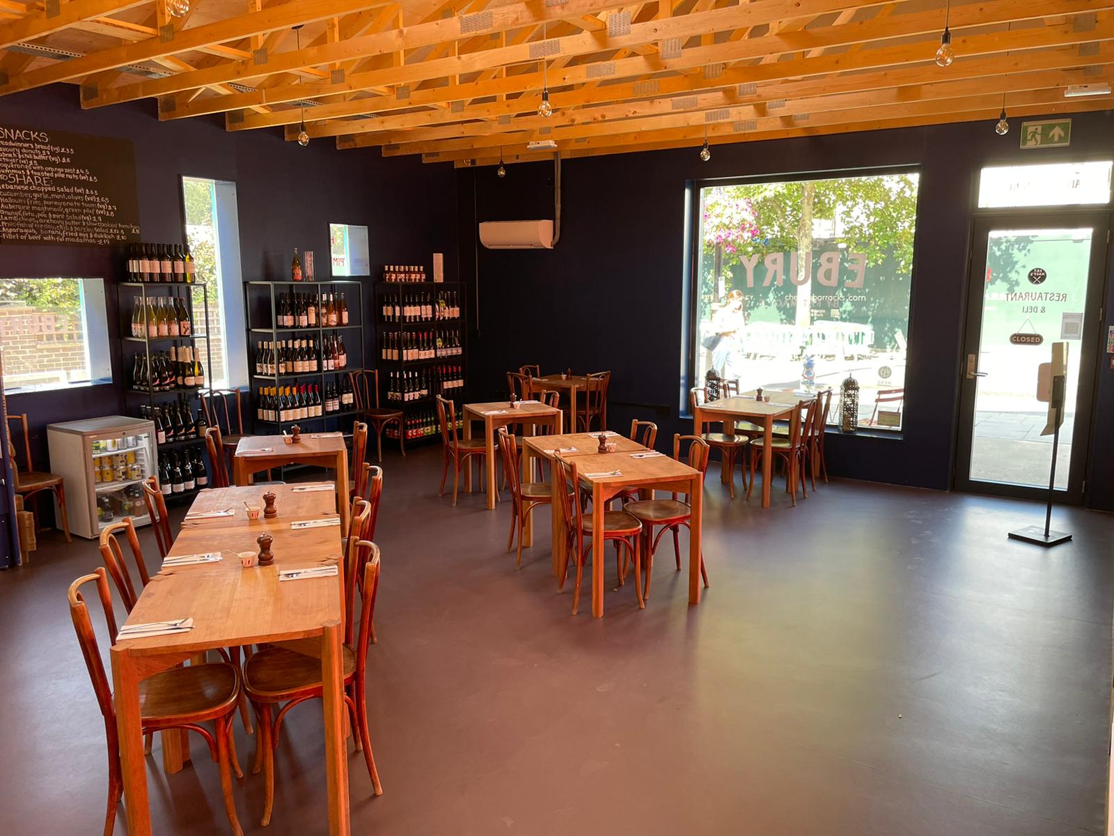 Cozy event space with wooden tables, ideal for workshops and private dinners.