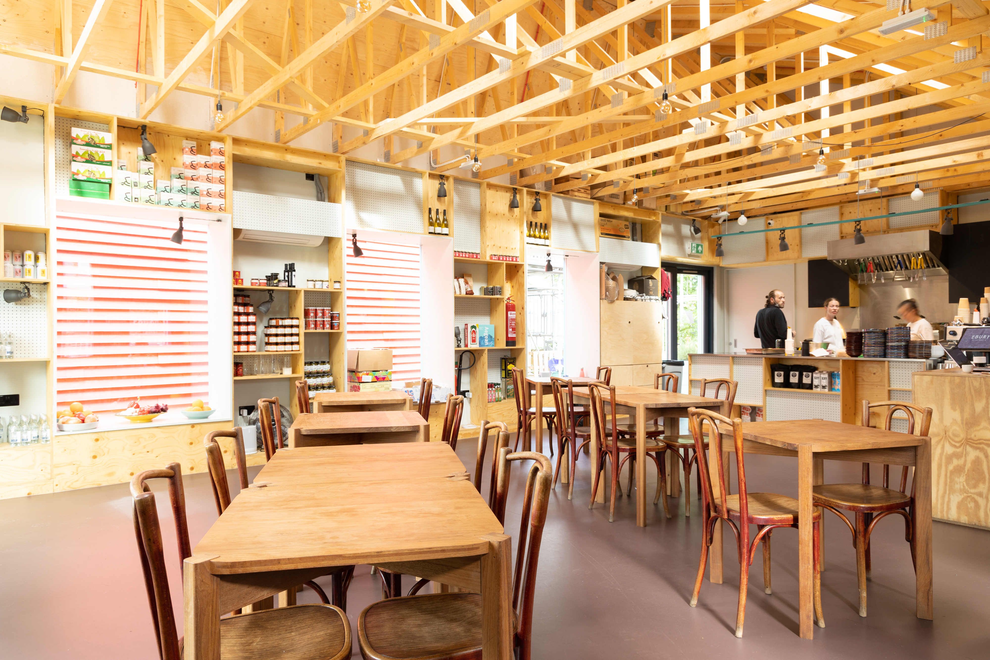 Modern open-concept venue with warm wood decor for casual meetings and events.