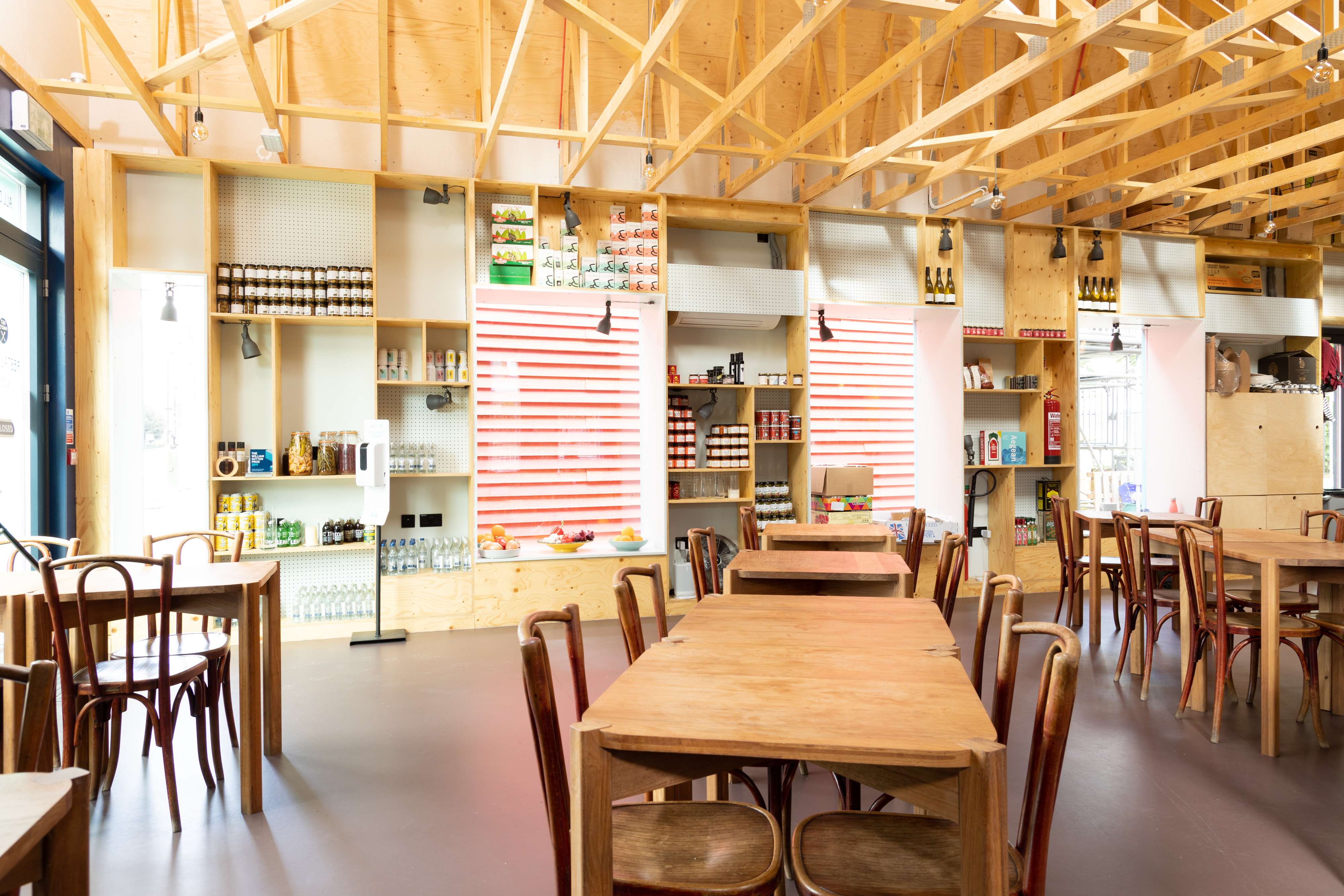 Modern open-concept venue with warm wood decor for casual meetings and events.