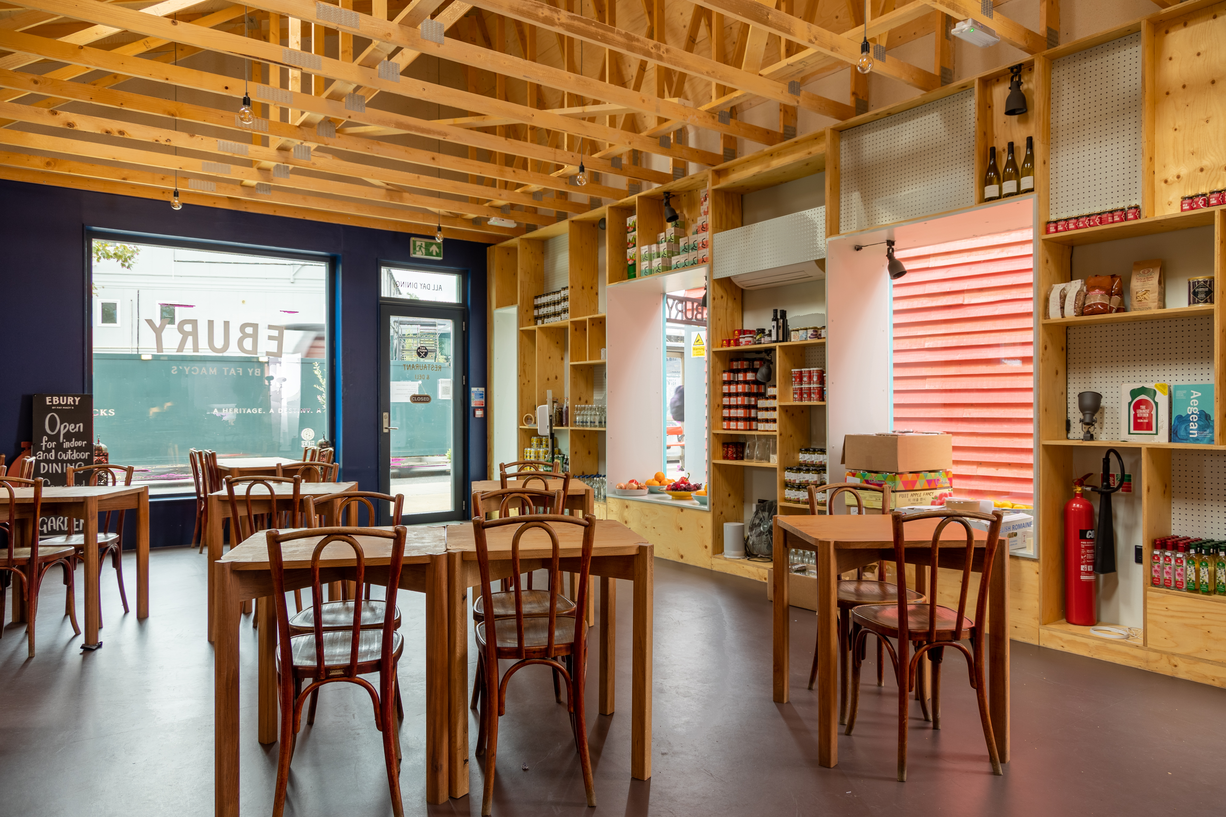 Modern event space with wooden beams, ideal for casual meetings and workshops.