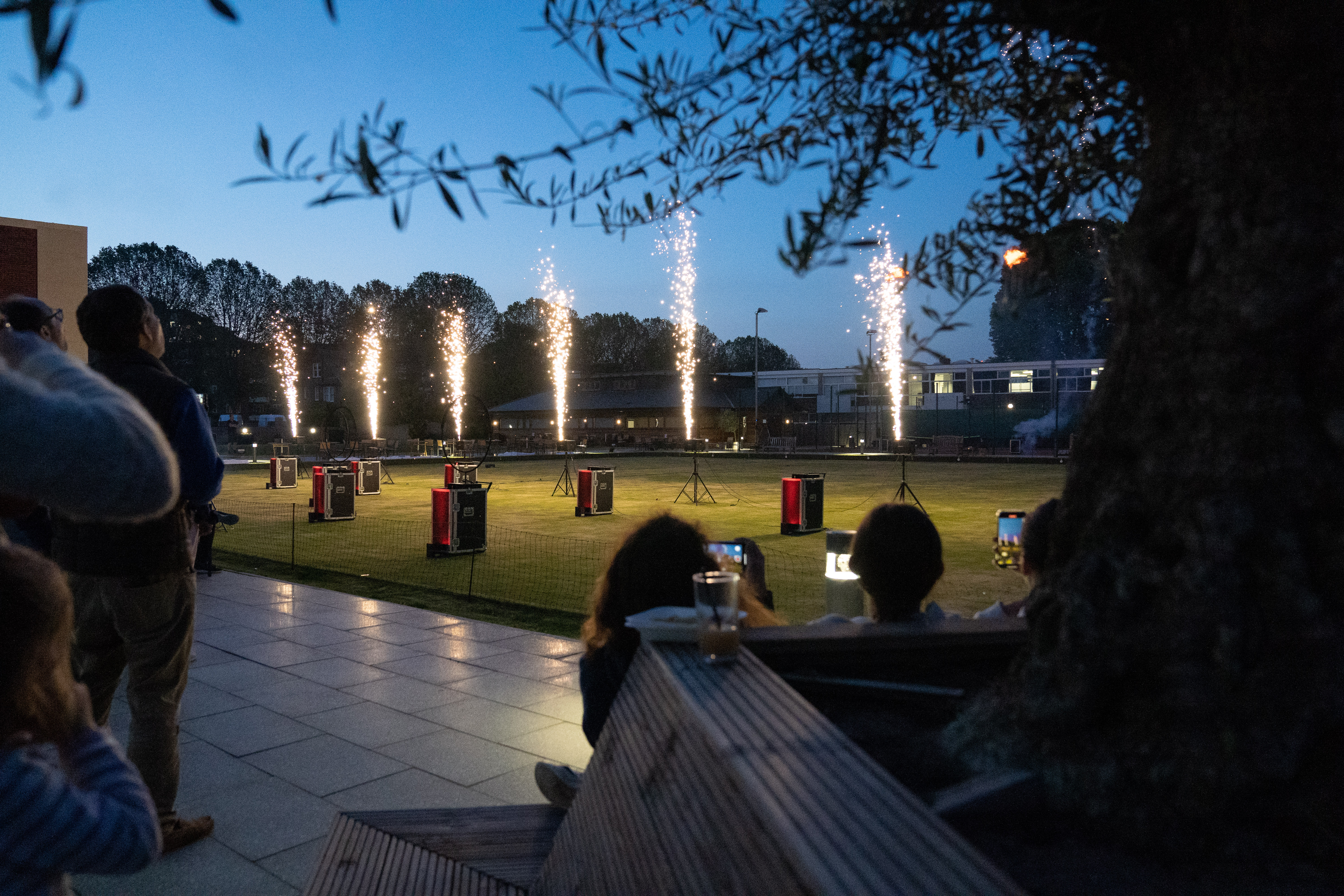 Vibrant outdoor event at Parsons Green Club with fireworks display and seating.
