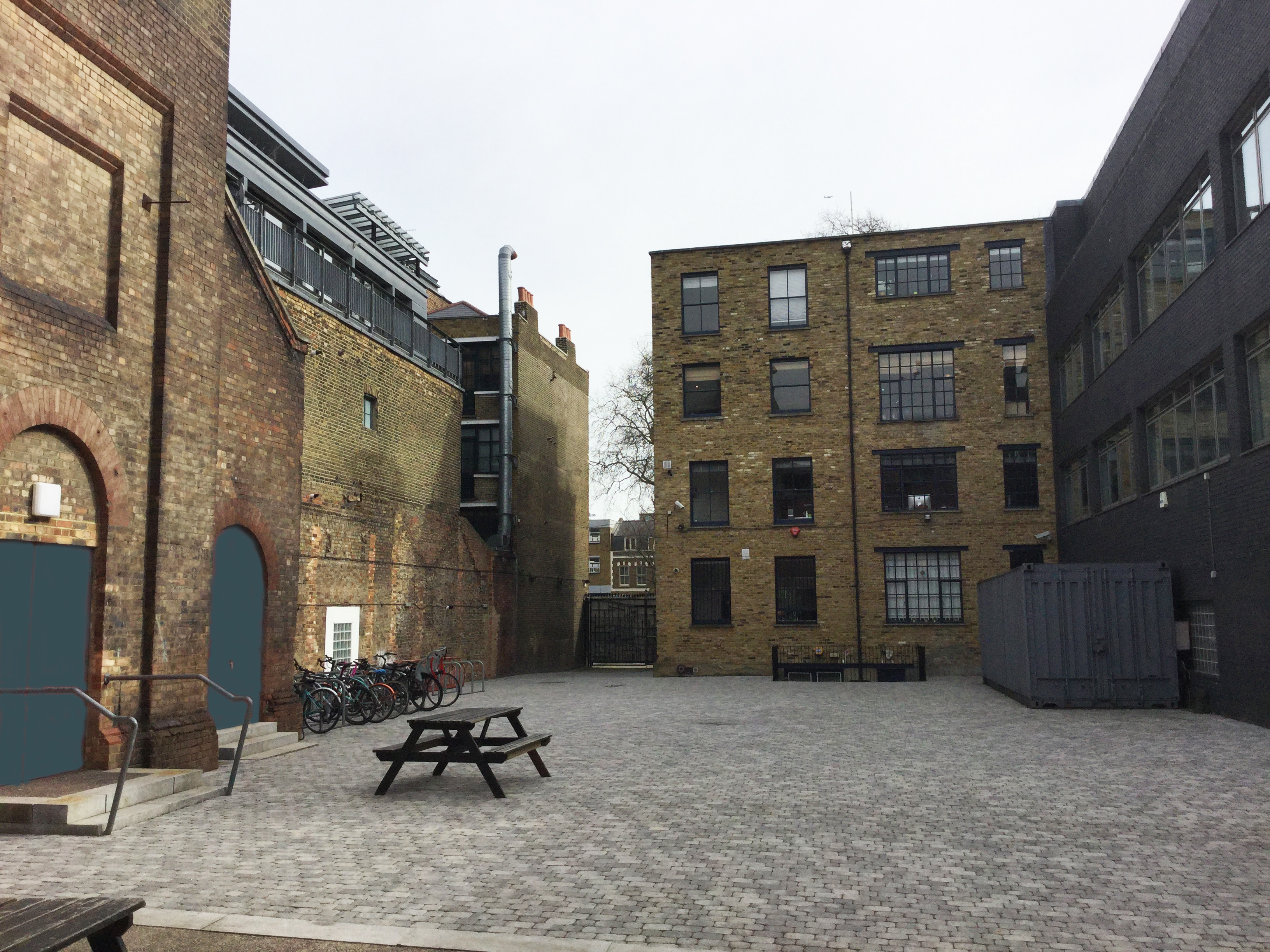 Courtyard in Shoreditch Electric with picnic table for casual gatherings and events.