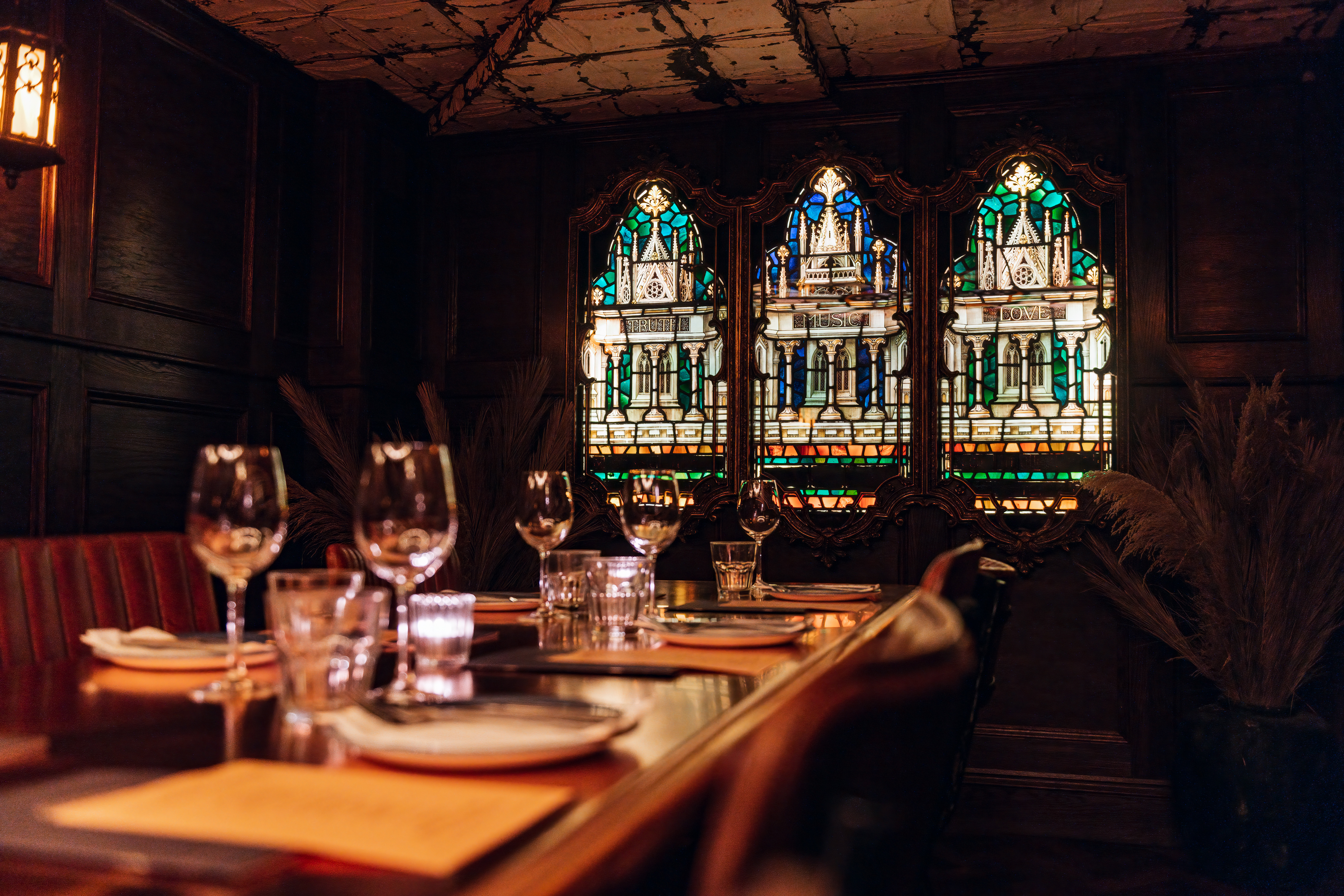 Private dining room with stained glass, ideal for upscale events and corporate dinners.