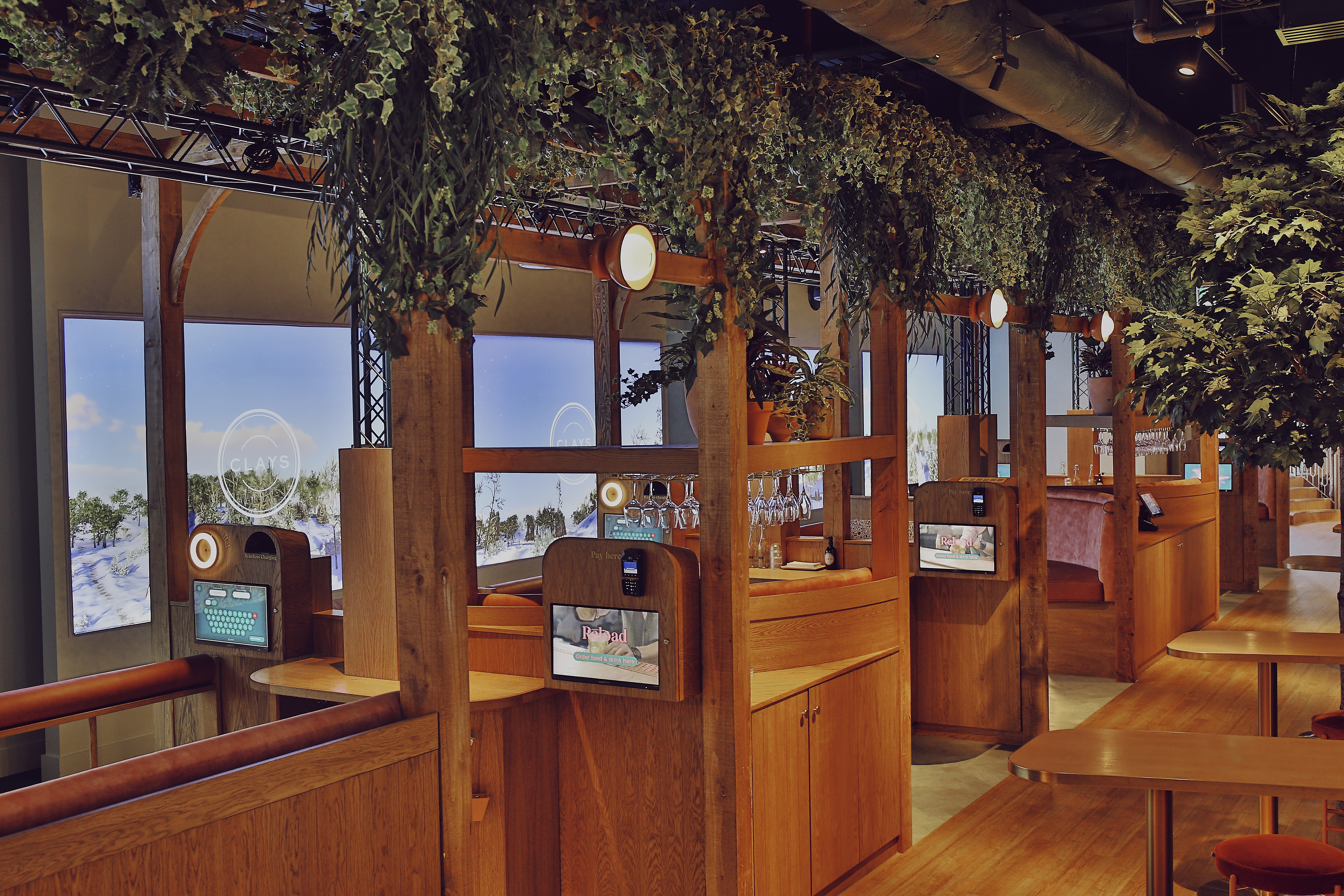 Modern event space at Clays Canary Wharf with wooden booths, ideal for meetings and collaboration.