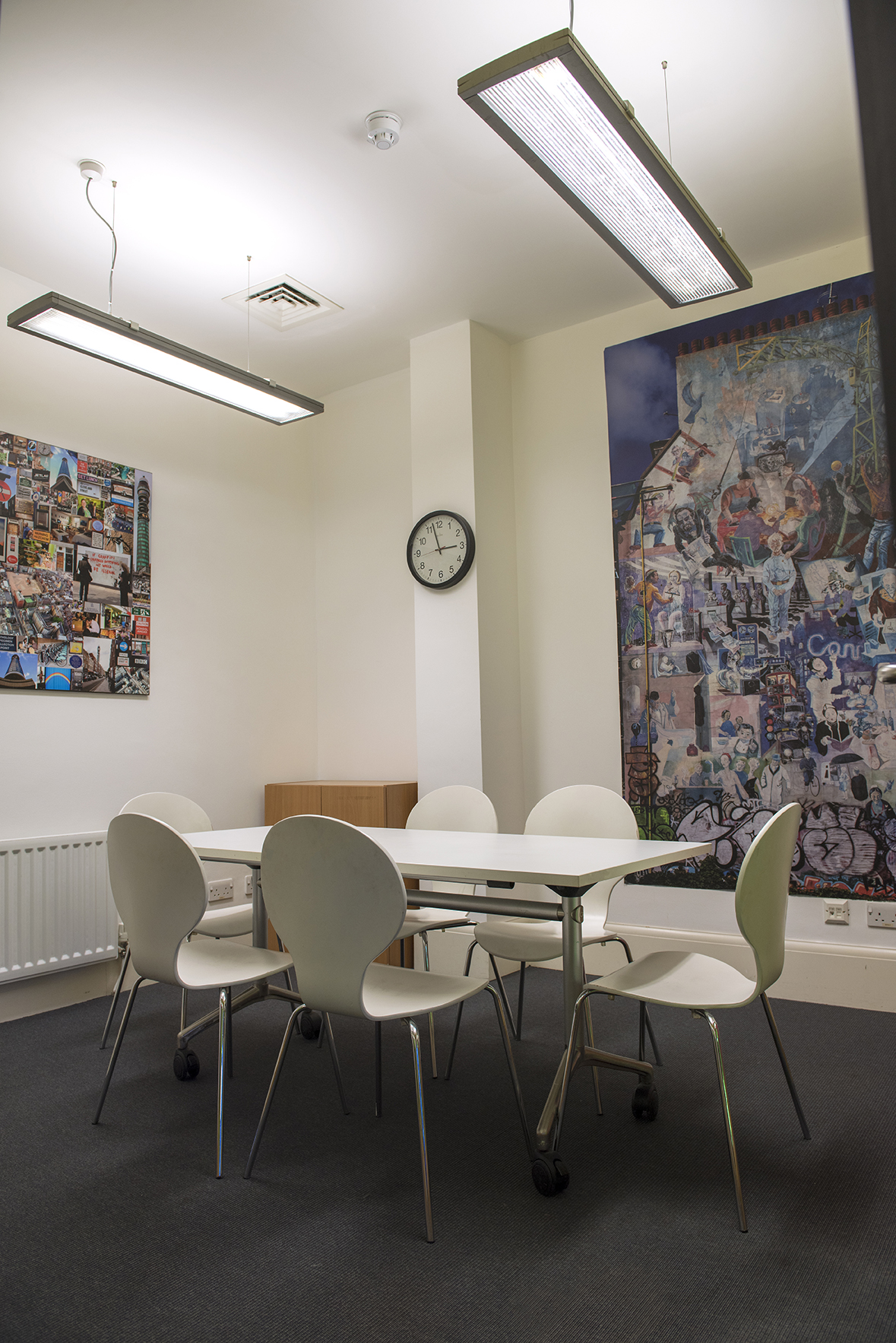 Modern meeting room in Fitzrovia Community Centre with minimalist table and ergonomic chairs.
