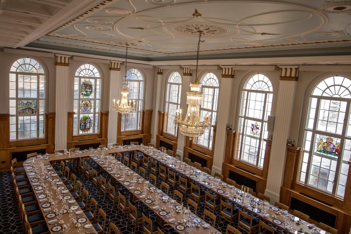 Elegant banquet hall with chandeliers, ideal for formal dinners and corporate events.