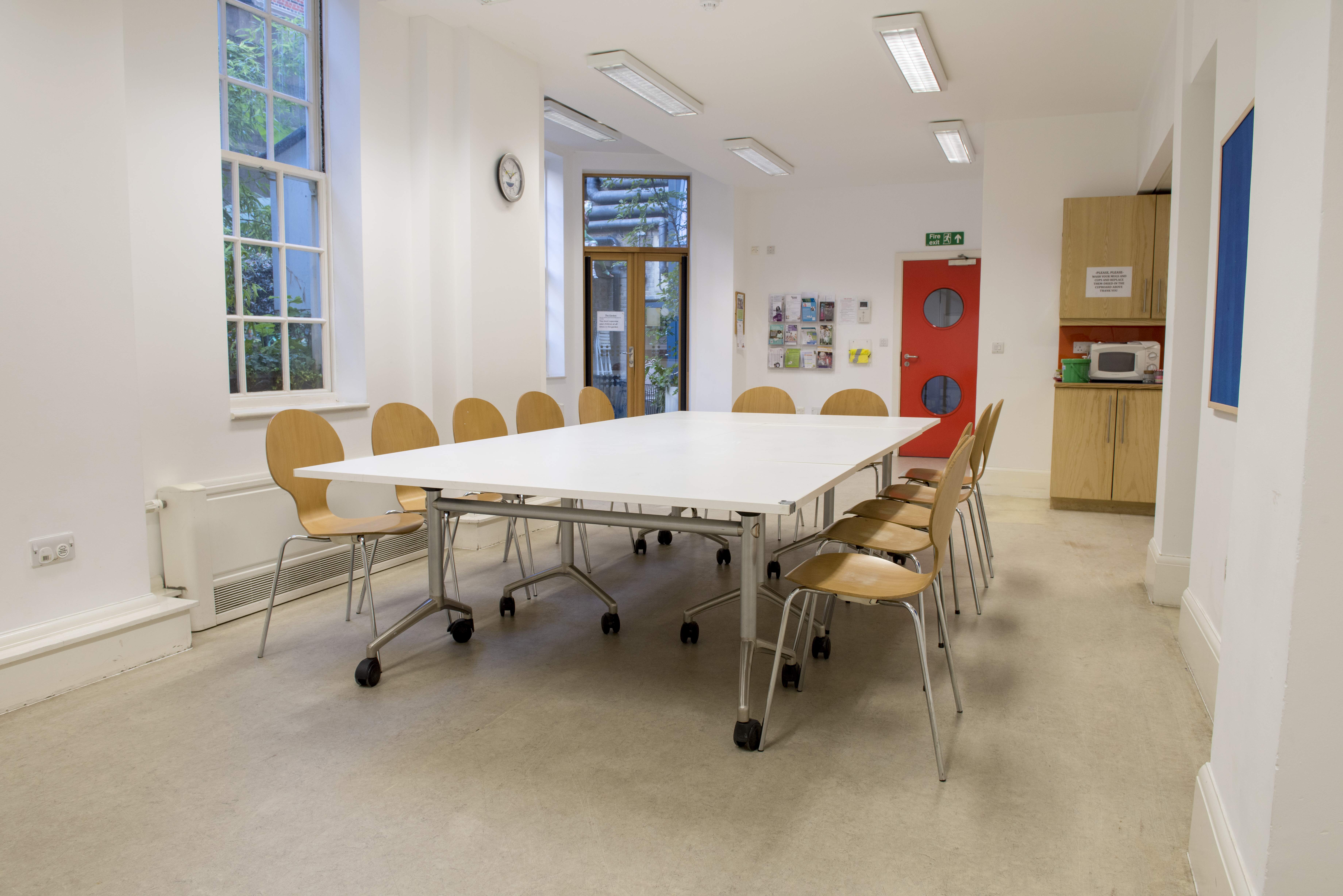 Owen Room at Fitzrovia Centre: bright meeting space with flexible table for workshops.