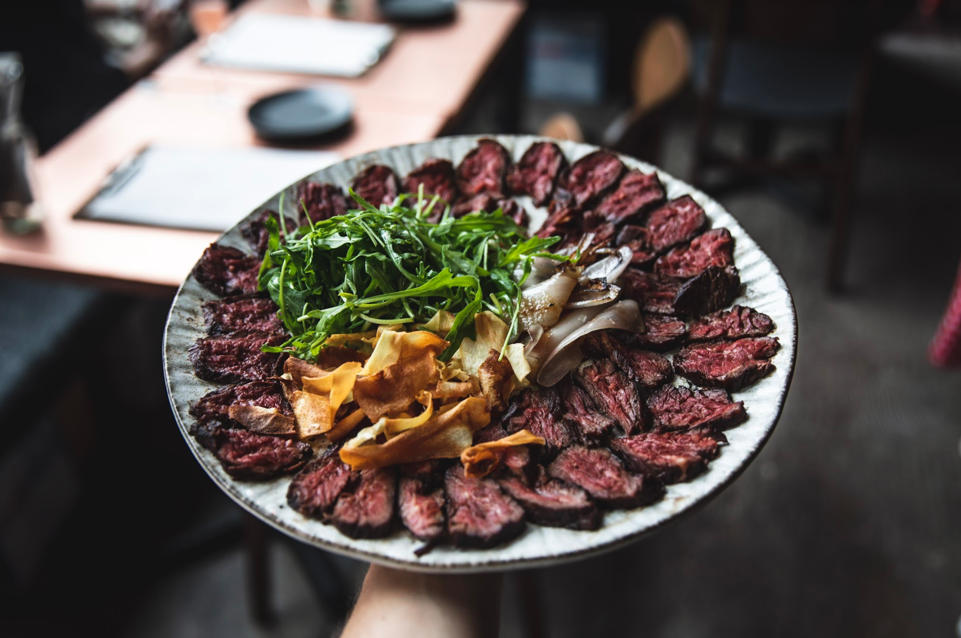 Sliced meat platter with greens at The Mezzanine, VAGABOND MONUMENT event catering.