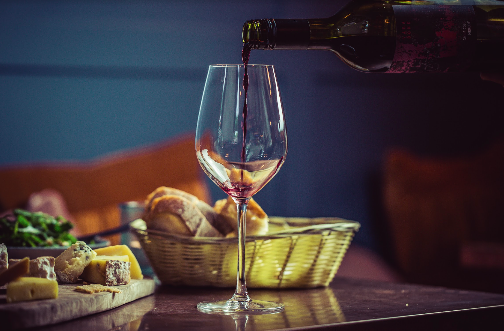 Elegant table setting with red wine, cheese, and bread for networking events.