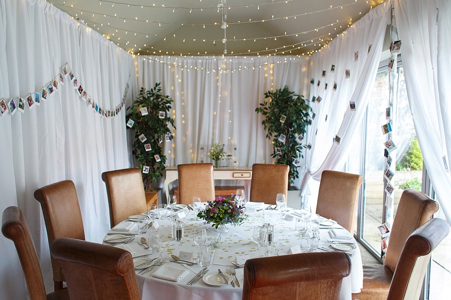 Elegant round table in The Hoste Arms' Garden Room for corporate meetings and events.