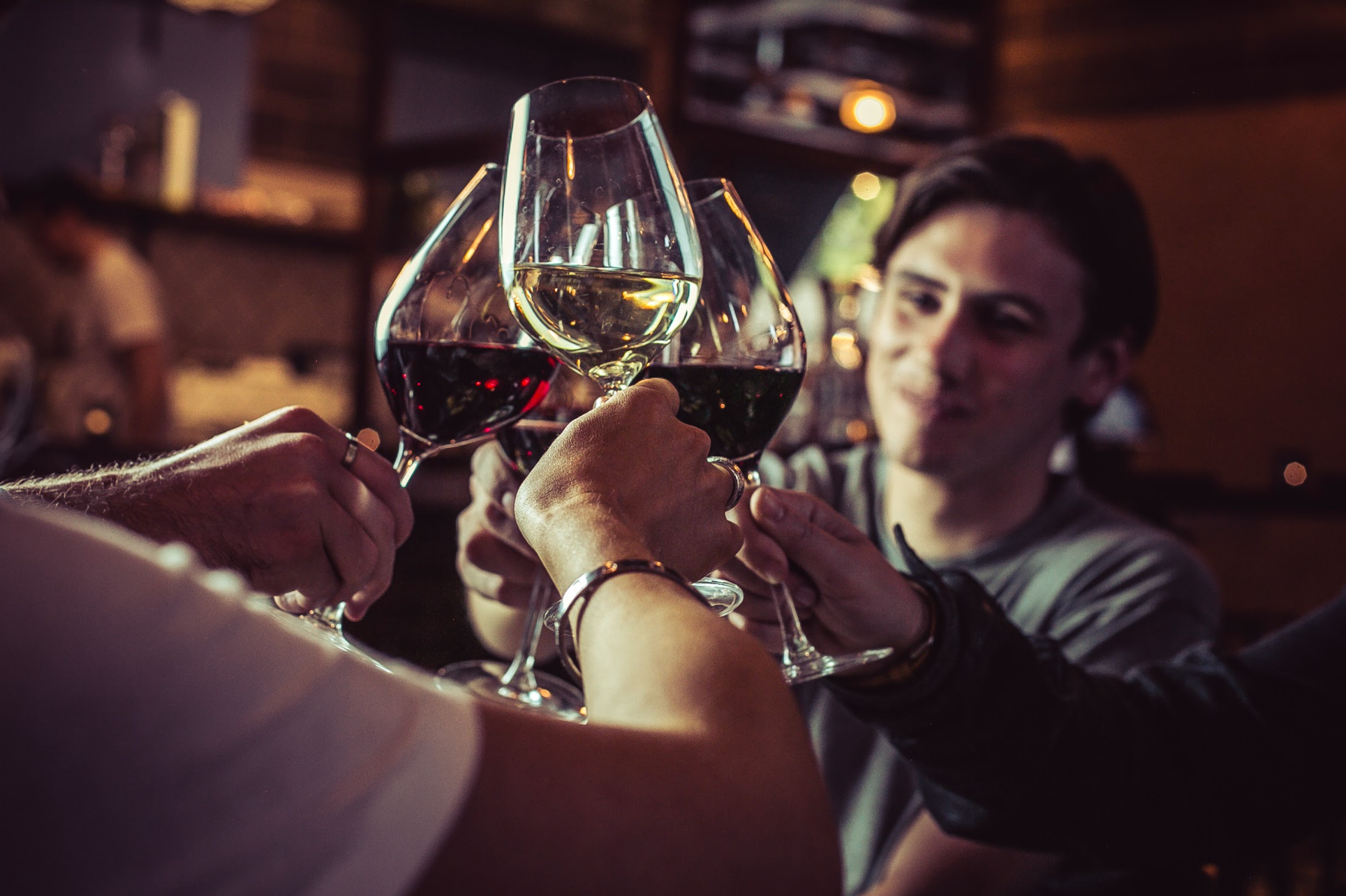 Celebratory toast at VAGABOND MONUMENT, showcasing networking and curated wines.