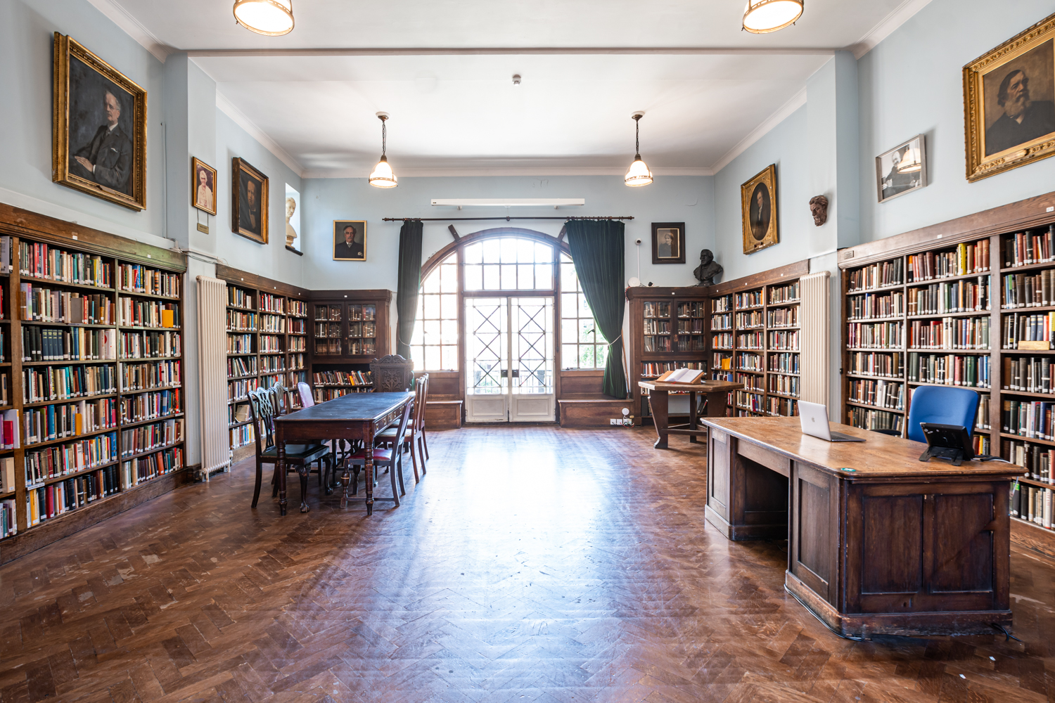 Spacious Conway Hall library with wooden bookshelves, perfect for meetings and seminars.