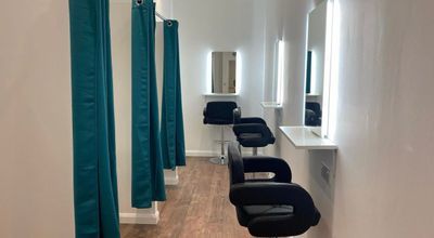 Photography studio with styling stations and teal curtains for event preparation.