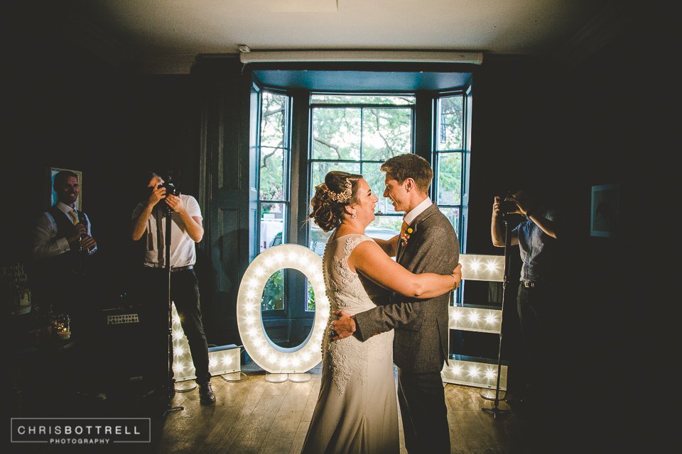 Wedding reception first dance in The Pembroke Suite with "LOVE" backdrop.