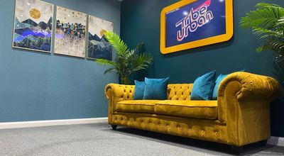 Vibrant Lounge Studio with yellow sofa, ideal for networking and informal meetings.