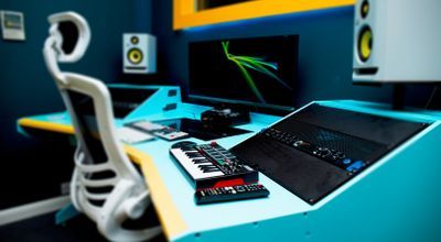 Modern music studio with audio-visual setup for hybrid events and live streaming.