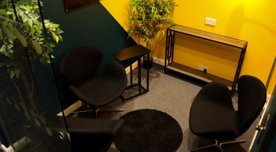 Cozy meeting space with vibrant yellow walls for creative brainstorming sessions.