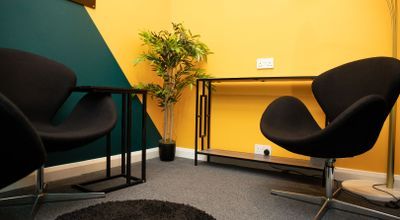 Modern meeting space with vibrant yellow walls, perfect for brainstorming sessions.