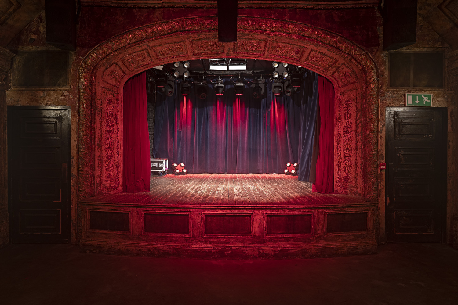 Ornate stage with red lighting at Exclusive Hire, Omeara for events and performances.