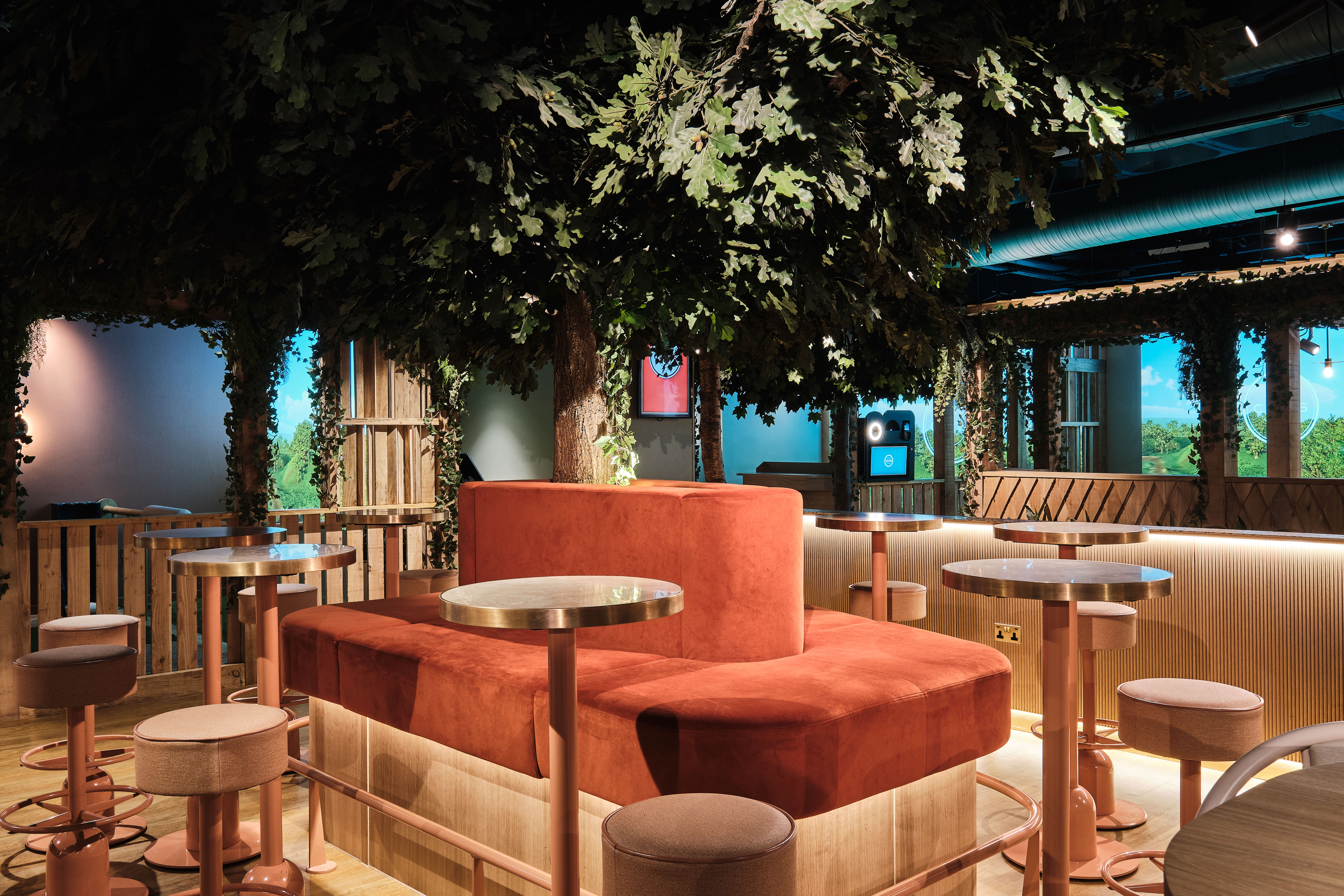 Cozy event space with elevated seating and greenery at Clays Moorgate for networking.