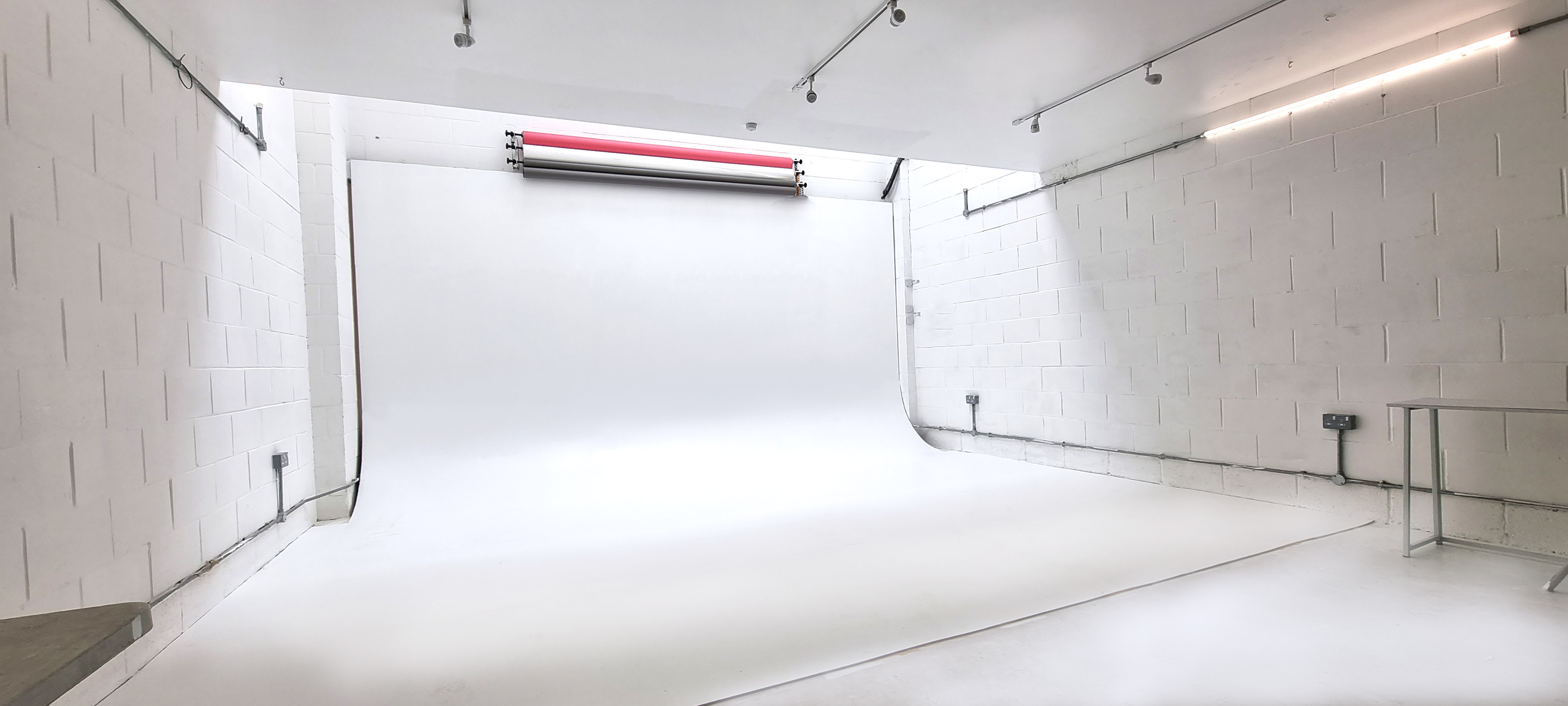 Minimalist photography studio with natural light for events and workshops.