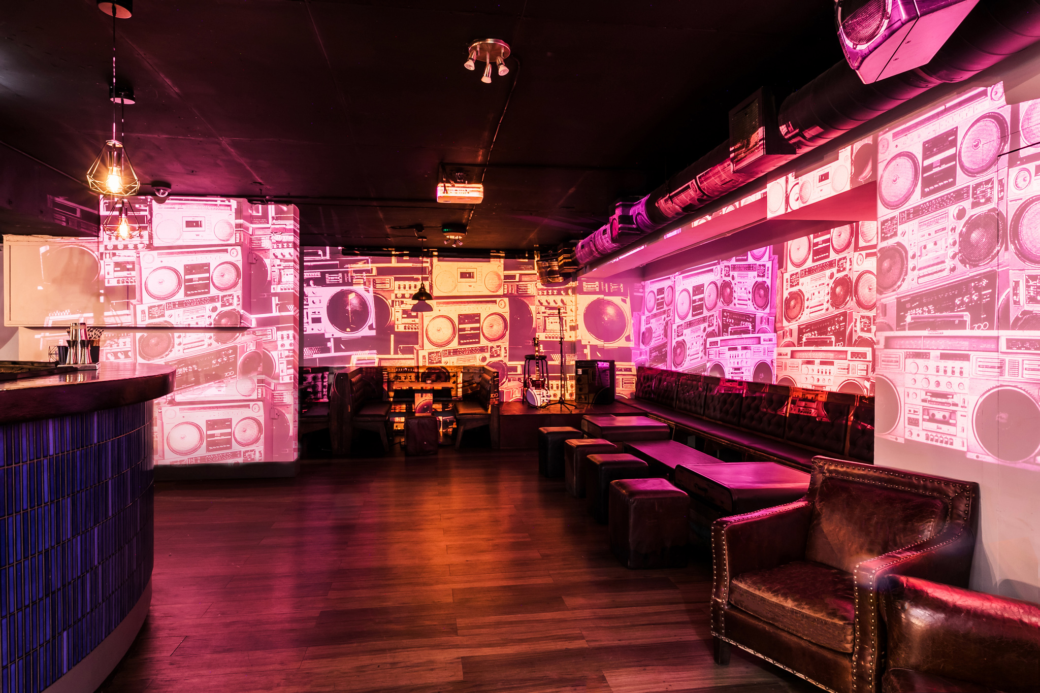 Vibrant Notting Hill Arts Club venue with colorful projections for networking events.