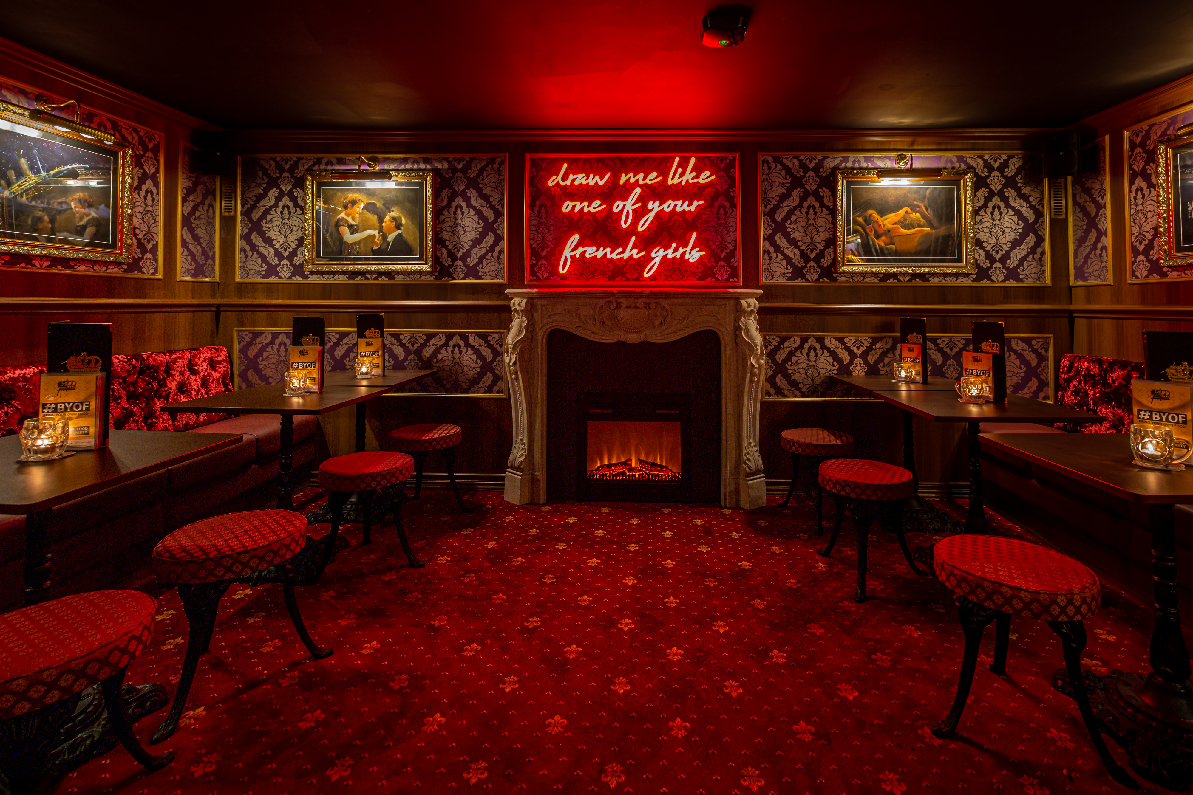 Stylish London Cocktail Club Clapham with rich red decor, ideal for private events.
