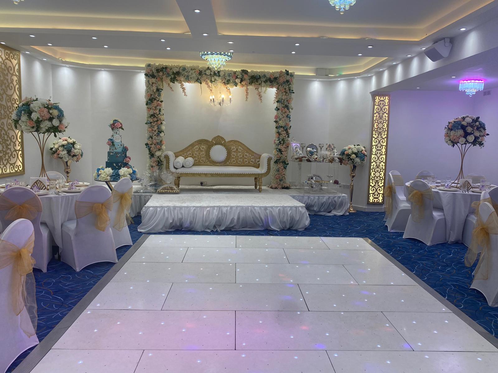 Elegant wedding venue with white and gold decor, ideal for formal gatherings.