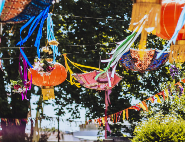 Vibrant outdoor event space with colorful lanterns for weddings and festivals.