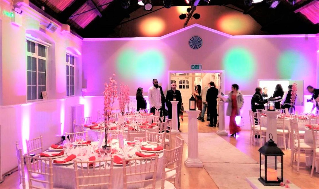 Elegant event space with round tables, perfect for weddings and corporate gatherings.