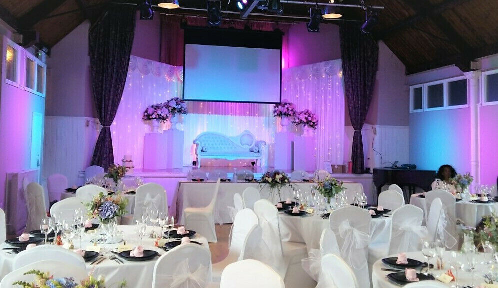 Elegant event space with floral decor, ideal for weddings and formal gatherings.