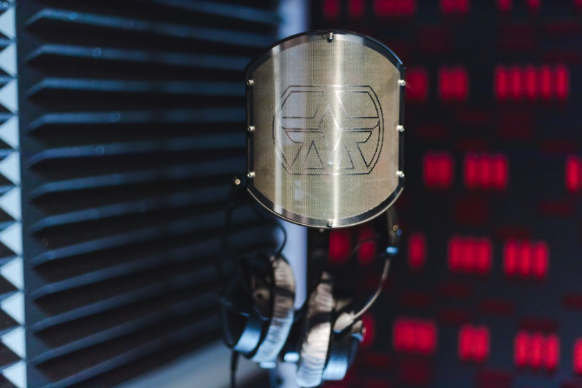 Professional microphone in soundproof studio for podcasts and live events.