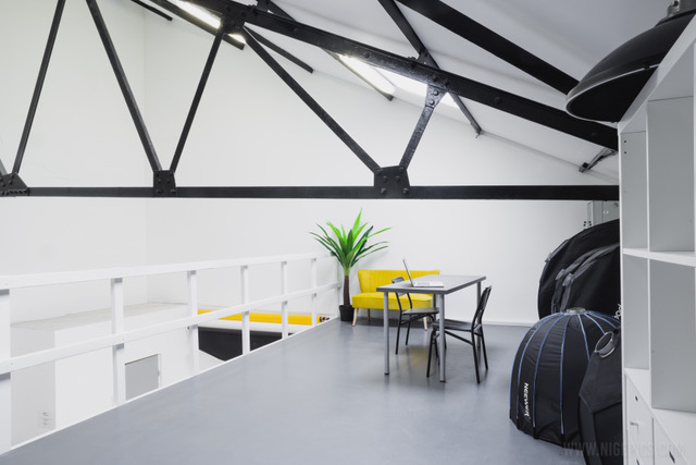 Modern minimalist meeting space with yellow seating for creative workshops.