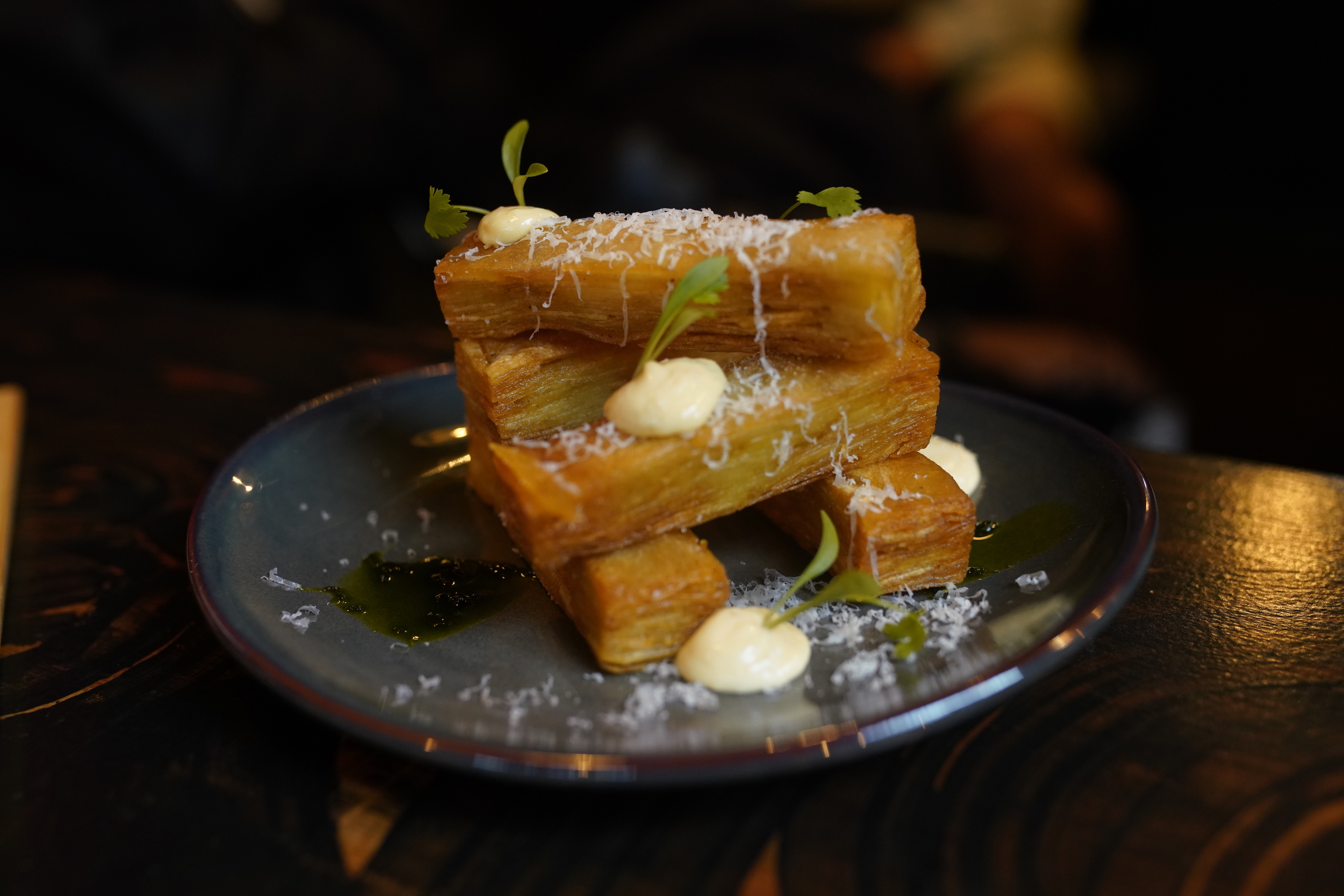 Golden-brown pastries with microgreens at Lagos Bar event catering.